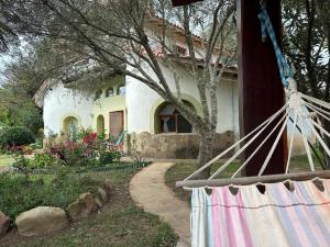 a house with a hammock in front of it at Hotel el Amanecer in Samaipata