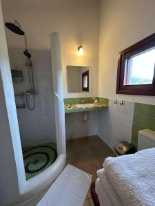 a bathroom with a shower and a sink and a tub at Hotel el Amanecer in Samaipata +33 photos