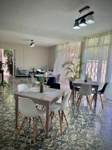a dining room with tables and white chairs at Casa 96 in Guatemala