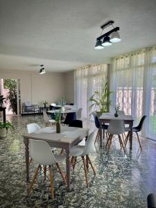 a dining room with tables and chairs and windows at Casa 96 in Guatemala