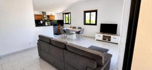 a living room with a couch and a table at L' Aurore de Cassandre in Saint-Paul