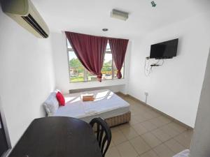 a small room with a bed and a window at Swing & Pillows - Kuala Selangor in Kuala Selangor +9 photos