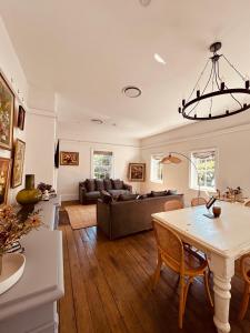 a living room with a table and a couch at The Berrima Vault House in Berrima