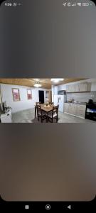 a living room with a table and a kitchen at Complejo El Mirador in Calingasta