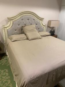 a large white bed with a large headboard and pillows at Apartamento Dulces Sueños in Bahia