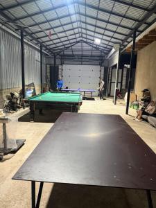 a room with a pool table in a garage at Гостевой дом БАЯН in Cholpon-Ata
