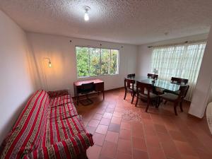 a bedroom with a table and a bed and a dining room at Habitaciones Stonehaven Ruitoque in Piedecuesta