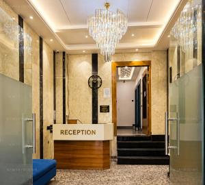 a lobby with a reception desk and a chandelier at New Skyrooms in Varanasi