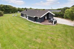 a small house with a deck and a yard at LF750-Vestervig-Gunhildsvej-30 in Vestervig