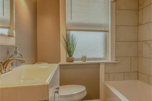 a bathroom with a sink and a toilet and a window at BurgBnB Riverfront in Harrisburg +37 photos