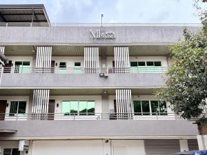 a building with a sign on the side of it at MF Suites in Manolo Fortich