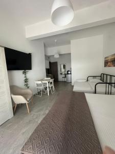 a living room with a couch and a table at AsproLux Seaside Studios in Asprovalta