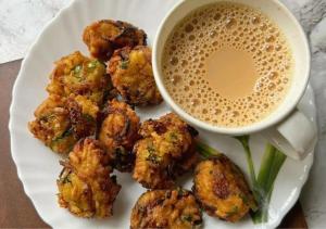 a plate of food with a cup of coffee at The Kishan's Nest in Mathura