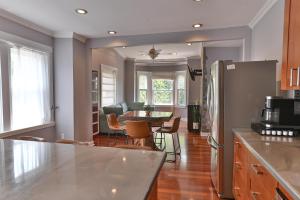 a kitchen and living room with a table and chairs at BurgBnB Riverfront in Harrisburg