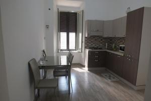 a kitchen with a table and chairs and a dining room at Casa Archimede in Syracuse