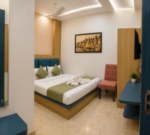 a hotel room with a bed and a chair at New Skyrooms in Varanasi