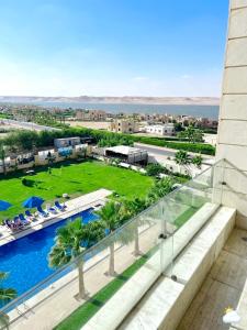 a view of a resort with a pool and palm trees at منتجع لوريت in Qaryat at Ta‘mīr as Siyāḩīyah