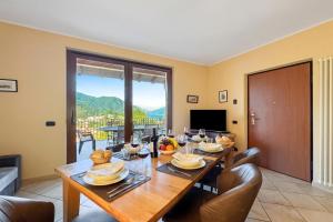 a dining room with a table and chairs with a view at Clubhouse in Menaggio
