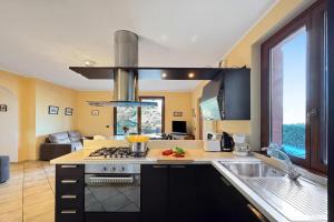 a kitchen with a sink and a stove top oven at Clubhouse in Menaggio
