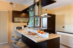 a kitchen with a counter with a sink and a stove at Clubhouse in Menaggio +18 photos