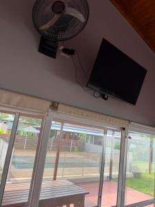 a room with a fan and a flat screen tv at Alborada in Gualeguaychú