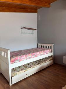 a white bed in a room with at Alborada in Gualeguaychú +2 photos