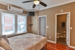 a bedroom with a bed and a ceiling fan at BurgBnB Riverfront in Harrisburg
