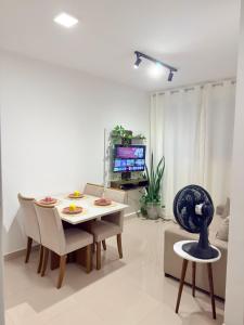 a living room with a table and chairs and a television at Auréa Residência - a 500 m da Praia in Cabedelo +37 photos