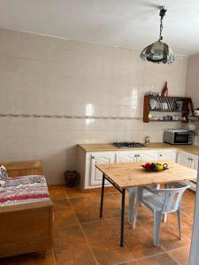 a kitchen with a wooden table and a table at Dar nawara in Kelibia +5 photos