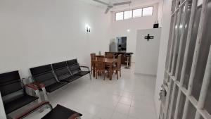 a living room with black couches and a table at Vacation Villa - Katunayake in Kotugoda