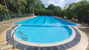a large swimming pool with blue water at Vacation Villa - Katunayake in Kotugoda