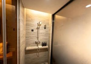 a shower in a bathroom with a glass door at Atour Hotel Kunming Hi-tech Wuyue Plaza in Kunming +26 photos