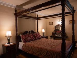 a bedroom with a canopy bed and two lamps at Lochinvar House in Lochinvar +67 photos