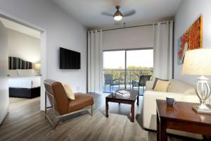 a living room with a couch and a bed and a table at Meliá Orlando Celebration in Orlando