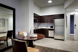 a kitchen with a table and a refrigerator at Meliá Orlando Celebration in Orlando