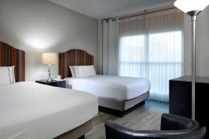 a hotel room with two beds and a window at Meliá Orlando Celebration in Orlando