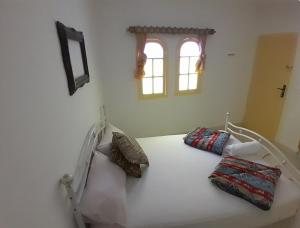 a white bed with pillows on it in a room at San Marcelo De Tangier in Tangier