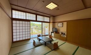 a living room with a table and chairs and a large window at WELLNESS PARK IWAKI Iwaki Yuttarikan in Iwaki