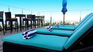 a blue couch with pillows on a balcony at Anarva Hotel & Spa in Mount Lavinia