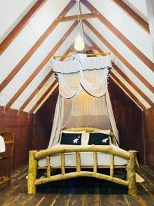a bedroom with a wooden bed in a attic at Sigiri Veenus Tree House in Sigiriya