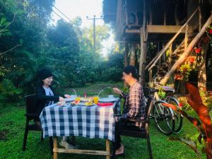 two women sitting at a table eating food at Sigiri Veenus Tree House in Sigiriya
