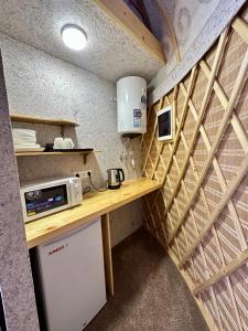 a small kitchen with a counter in a tiny house at Tangnuru eco yurts in Bosteri