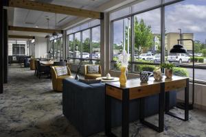 a lobby with couches and a table and windows at Hilton Garden Inn Jackson in Jackson