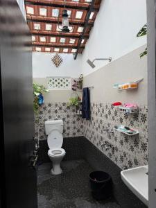 a bathroom with a toilet and a sink at Koppalu Heritage in Vastāra