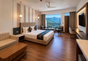 a hotel room with a bed and a living room at Kavin - The Chail Resort in Chail +32 photos
