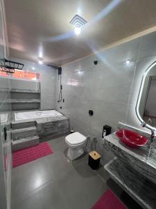a bathroom with a tub and a toilet and a sink at Pousada Lumiera House in Foz do Iguaçu +96 photos