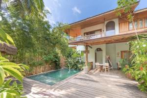 a house with a swimming pool and a wooden deck at Camanolo Residence in General Luna