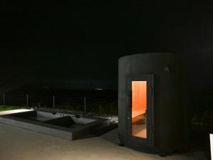 a dark room with a door in the night at FOG villa&spa in Kirishima