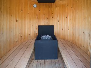 a room with a box in the corner of a wooden wall at FOG villa&spa in Kirishima