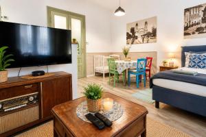 a living room with a large flat screen tv at M37 Apartman in Debrecen